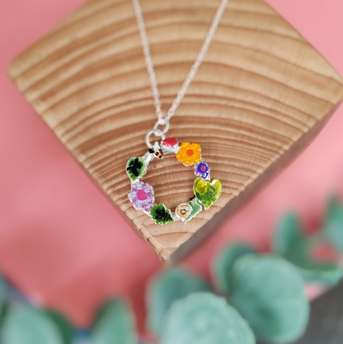 Round Wreath Necklace With Orange Flower And Snail